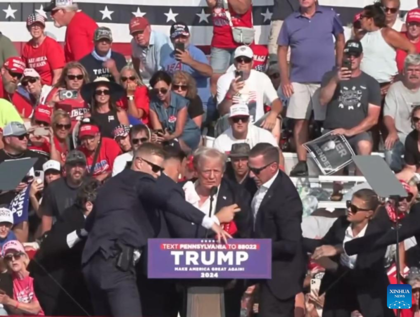 Donald Trump being helped off the stage at a rally in Butler, Pennsylvania