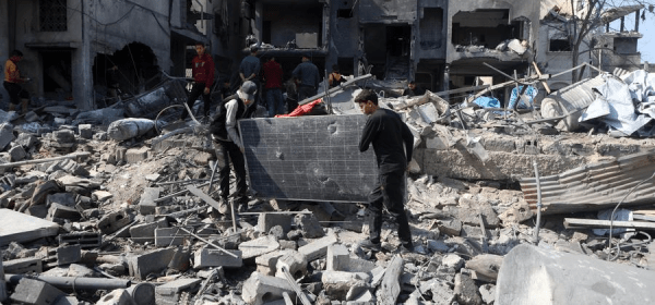 People clear debris of buildings damaged by Israeli airstrikes in the Shuja'iyya neighborhood, east of Gaza City, on March 18, 2025. (Photo by Rizek Abdeljawad/Xinhua)