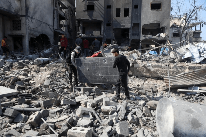 People clear debris of buildings damaged by Israeli airstrikes in the Shuja'iyya neighborhood, east of Gaza City, on March 18, 2025. (Photo by Rizek Abdeljawad/Xinhua)