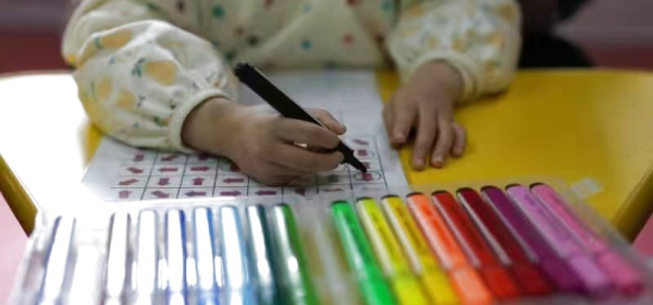This photo taken in March 2023 shows an autistic child taking a class at the Little Turtle children's services center in Shenyang, northeast China's Liaoning Province. (Xinhua)