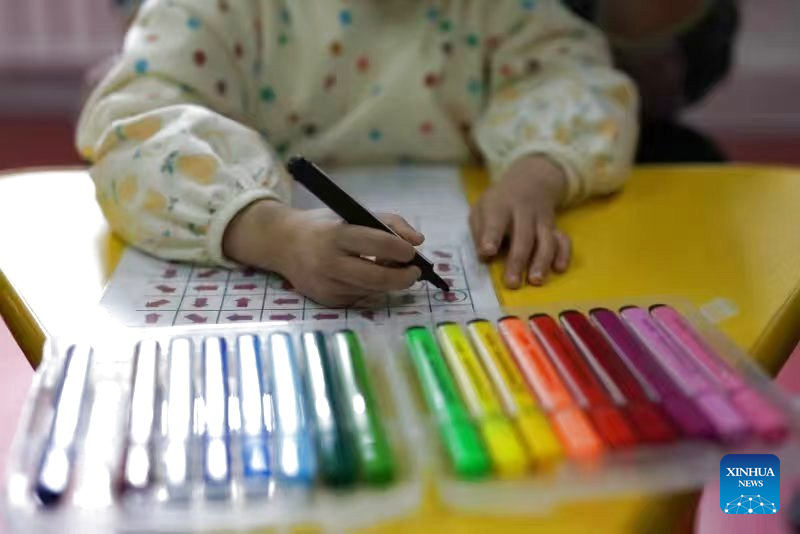This photo taken in March 2023 shows an autistic child taking a class at the Little Turtle children's services center in Shenyang, northeast China's Liaoning Province. (Xinhua)