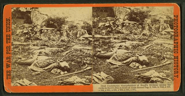 Dead Confederate sharpshooters of Hood's Division among the rocks in Devil's Den in front of Little Round Top.