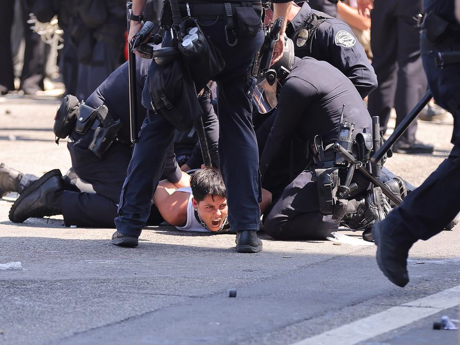 A protester is arrested by Los Angeles Police Department police officers in front of the Los Angeles Federal Detention Center, in Los Angeles, California, the United States, June 8, 2025. (Photo by Qiu Chen/Xinhua)