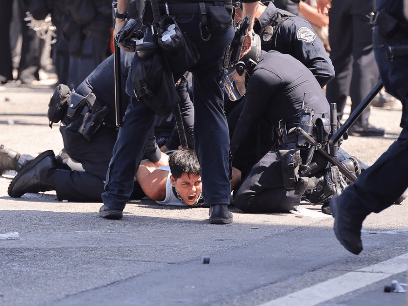 A protester is arrested by Los Angeles Police Department police officers in front of the Los Angeles Federal Detention Center, in Los Angeles, California, the United States, June 8, 2025. (Photo by Qiu Chen/Xinhua)
