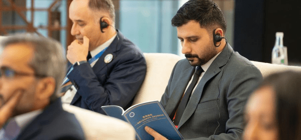 A guest reads a copy of the think tank report "Colonization of the Mind -- The Means, Roots, and Global Perils of U.S. Cognitive Warfare" during the Global South Media and Think Tank Forum 2025 in Kunming, southwest China's Yunnan Province, Sept. 7, 2025. (Xinhua/Gao Yongwei)