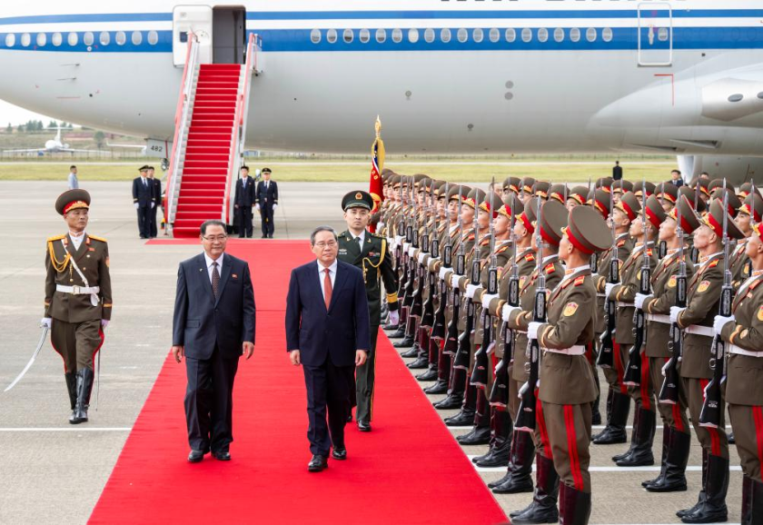 Chinese Premier Li Qiang, also a member of the Standing Committee of the Political Bureau of the Communist Party of China Central Committee, reviews the guard of honor with Pak Thae Song, premier of the cabinet of the Democratic People's Republic of Korea (DPRK) and presidium member of the Political Bureau of the Workers' Party of Korea (WPK) Central Committee, during a welcome ceremony at Pyongyang Sunan International Airport in Pyongyang, DPRK, Oct. 9, 2025.