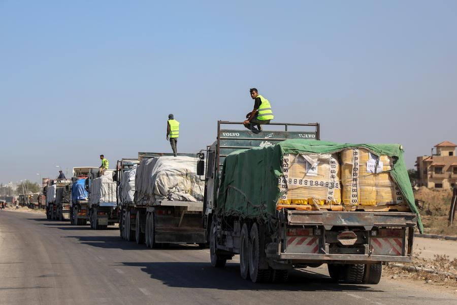 Trucks carrying aid supplies are seen in Deir al-Balah, central Gaza Strip, on Oct. 16, 2025. (Photo by Rizek Abdeljawad/Xinhua)