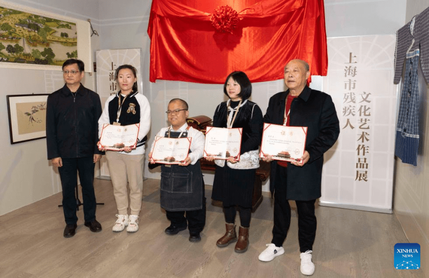 Representatives of disabled artists pose for a group photo during an exhibition held at the Sensory Experience Gallery of the Palace Museum in Beijing, capital of China, Nov. 21, 2025. Featuring artworks created by disabled artists from Shanghai, the exhibition kicked off here on Friday. Under the guidance of inheritors of intangible cultural heritages, these artists infused their love for life and reverence for culture into their works. (Xinhua/Cai Yang)