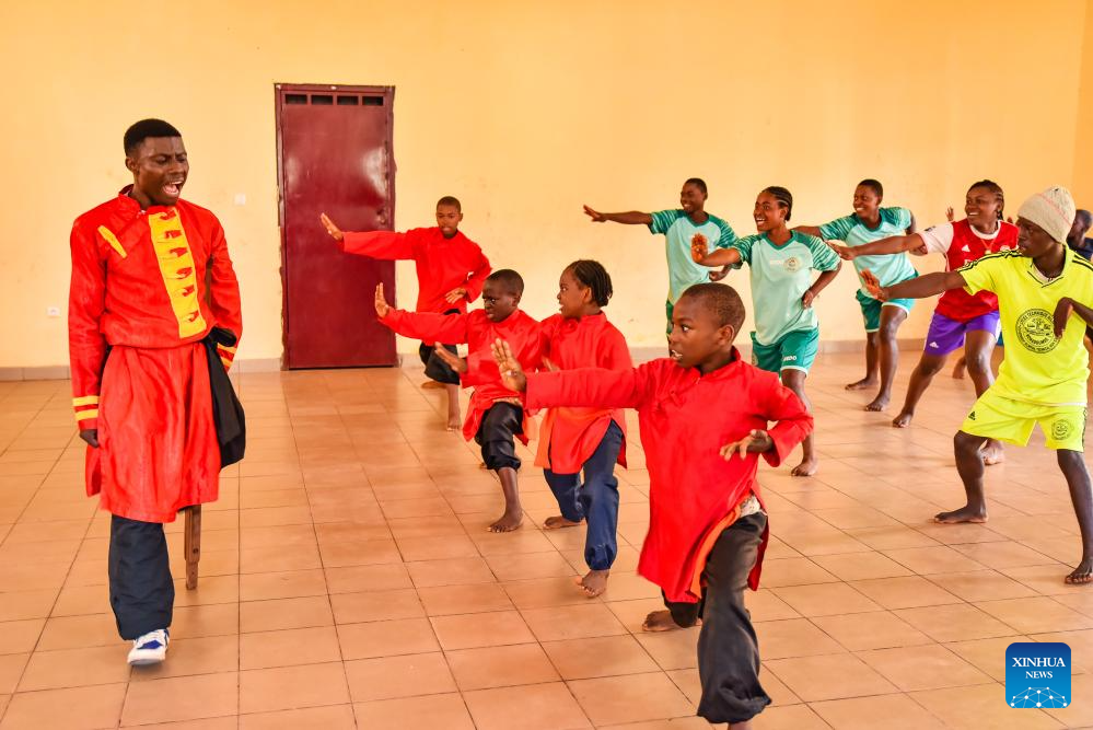 Martin Mangwandjo (1st L), a disabled Cameroonian, leads young learners in practicing Chinese martial arts moves at his training centre in Yaounde, Cameroon's capital, Nov. 18, 2025. (Photo by Kepseu/Xinhua)
