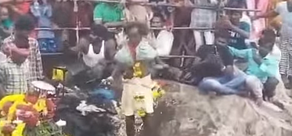 The temple priest Appa Pappayya, 49, climbs near-vertical rock cliff on oil-soaked edges several times every year as part of a ritual to appease Lord Gampamallayya and perform the puja in the temple on top of the hillock.