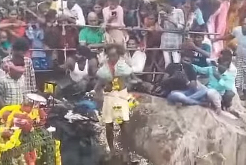 The temple priest Appa Pappayya, 49, climbs near-vertical rock cliff on oil-soaked edges several times every year as part of a ritual to appease Lord Gampamallayya and perform the puja in the temple on top of the hillock.