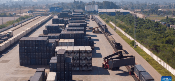 An aerial drone photo shows workers conducting container hoisting operations at the Vientiane South Station on the China-Laos Railway in Vientiane, capital of Laos, Nov. 29, 2025. (Photo by Kaikeo Saiyasane/Xinhua)