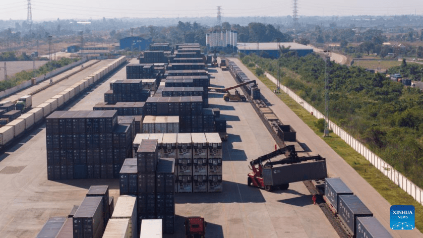 An aerial drone photo shows workers conducting container hoisting operations at the Vientiane South Station on the China-Laos Railway in Vientiane, capital of Laos, Nov. 29, 2025. (Photo by Kaikeo Saiyasane/Xinhua)