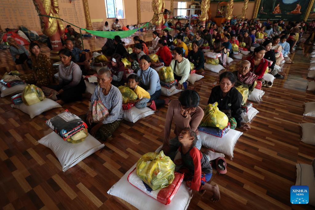 Cambodian evacuees receive relief items at a safe zone in Siem Reap province, Cambodia, on Dec. 11, 2025. (Photo by Sovannara/Xinhua)