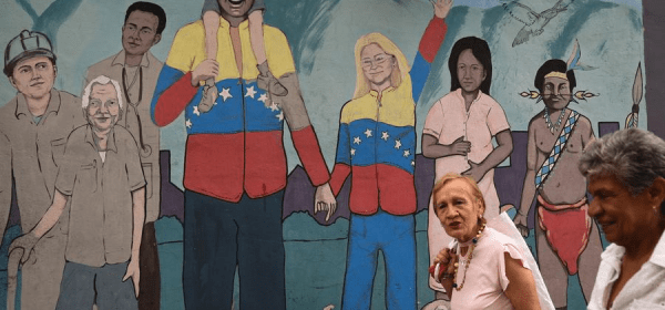 People walks past a mural in Caracas, Venezuela, Nov. 5, 2025. Venezuelan President Nicolas Maduro has repeatedly condemned Washington's actions as attempts to overthrow his government and expand the U.S. military influence in Latin America. (Photo by Marcos Salgado/Xinhua