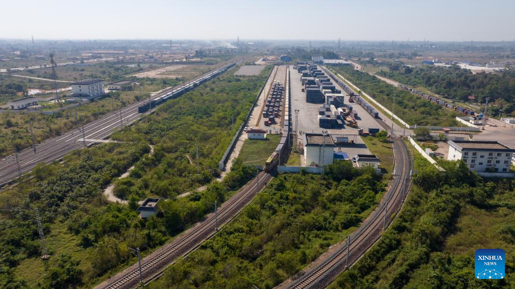 An aerial drone photo shows a container train carrying 1,000 tons of cassava starch bound for Zhengzhou, capital of central China's Henan Province, departing from the Vientiane South Station on the China-Laos Railway in Vientiane, capital of Laos, Nov. 29, 2025. (Photo by Kaikeo Saiyasane/Xinhua)