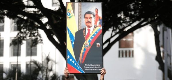 A person demonstrates near the Miraflores Palace in Caracas, the capital of Venezuela, on Jan. 3, 2026. The U.S. military launched a series of attacks against Venezuela early Saturday morning, reportedly capturing President Nicolas Maduro and flying him out of the country. (Str/Xinhua)
