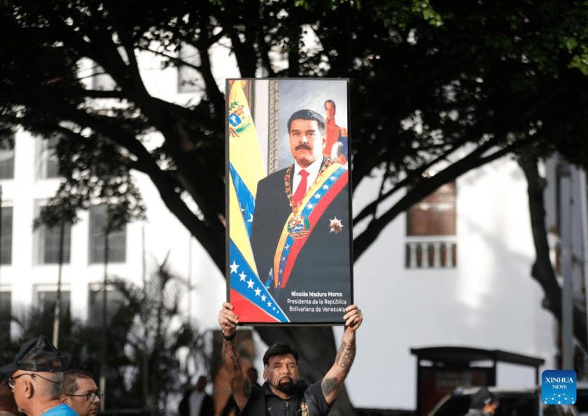 A person demonstrates near the Miraflores Palace in Caracas, the capital of Venezuela, on Jan. 3, 2026. The U.S. military launched a series of attacks against Venezuela early Saturday morning, reportedly capturing President Nicolas Maduro and flying him out of the country. (Str/Xinhua)
