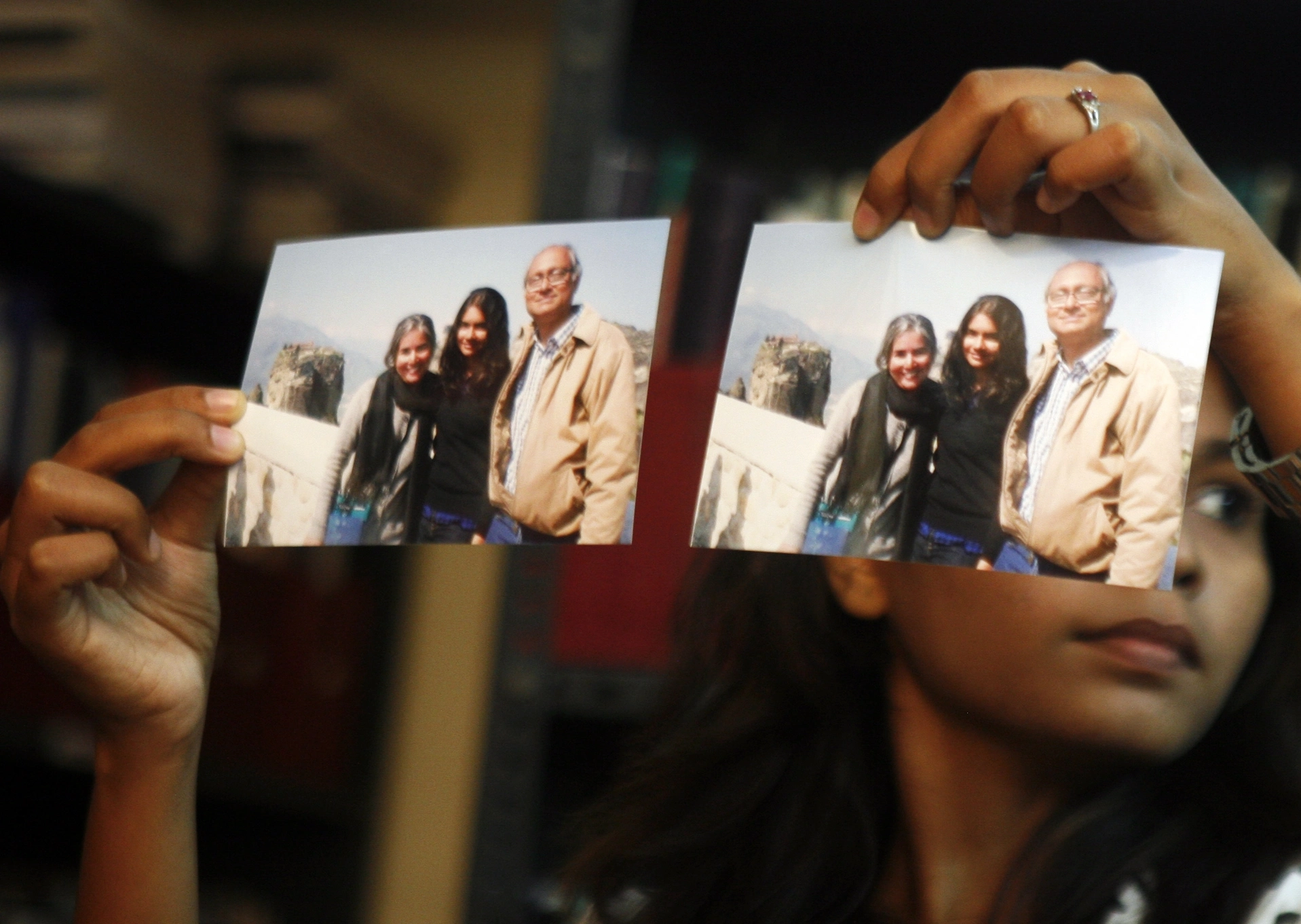 Photographs showing one of the passengers of the missing Malaysian Airlines aircraft Chandrika Sharma, left, her husband Narendran and daughter Meghna, are displayed during a press conference in Chennai, India, on March 12, 2014. | Arun Sankar K/AP