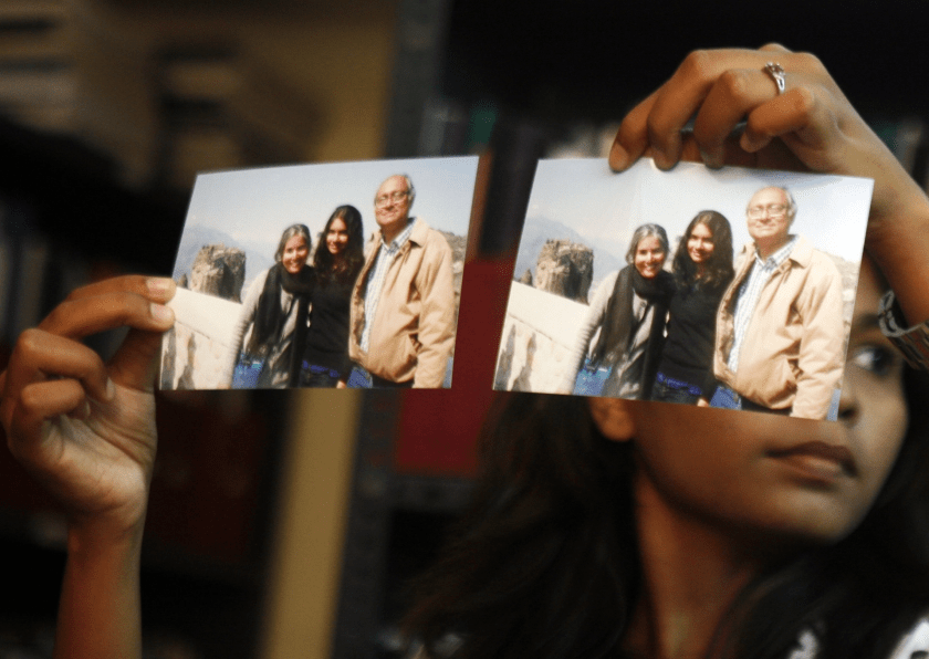 Photographs showing one of the passengers of the missing Malaysian Airlines aircraft Chandrika Sharma, left, her husband Narendran and daughter Meghna, are displayed during a press conference in Chennai, India, on March 12, 2014. | Arun Sankar K/AP