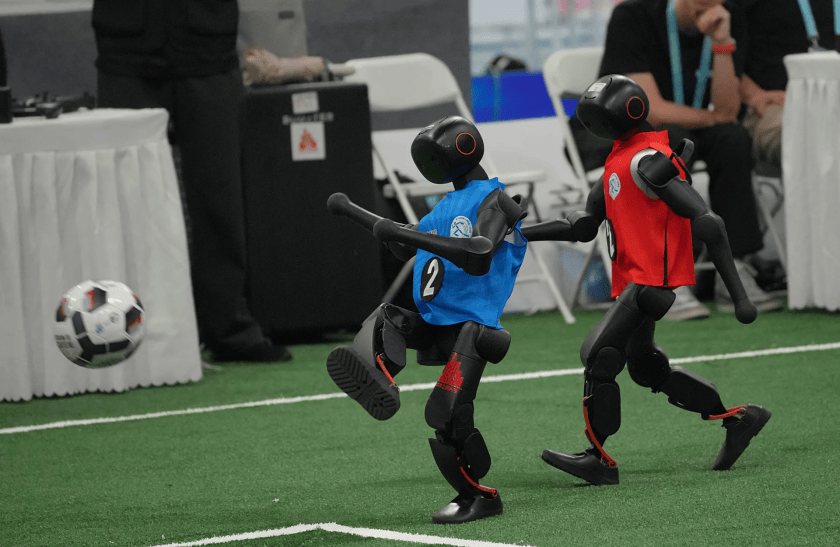 Robots play soccer during the World Humanoid Robot Games in Beijing, Sunday, Aug. 23, 2026.