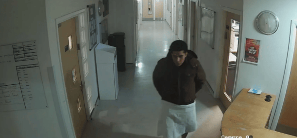 Rolando Torres-Pena walking in the unit, with his legs covered by material wrapped around his waist.
