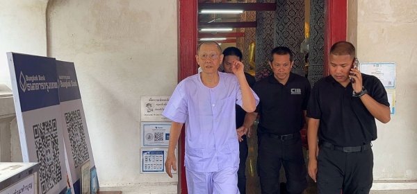 Police escort Atichote Thammavaro, formerly Phra Vajirayan, out of Wat Phutthaisawan in Ayutthaya after he was defrocked on Thursday